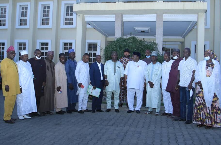 Senator Philip Aduda, middle in a group photograph with executives of the Nigeria Union of Teachers (NUT) at end of meeting in Abuja on Tuesday night