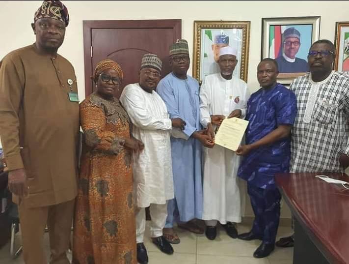 Representative of the FCT minister, Director for Human Resources Department (HRD) of the FCTA, Muhammad Bashir, FCT director of UBEB, Dr Hassan Sule presenting approval letter of 65 years retirement age for teachers to the FCT NUT Chairman, Comrade Stephen Knabayi in Abuja on Wednesday.