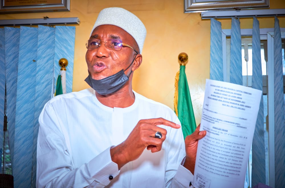 State APC chairman Alhaji Abdulmalik Usman display the court judgement which affirmed Alhaji Mohammed Angulu Loko as the party's chairmanship candidate in Abaji Area Council at the party secretariat in Abuja on Friday