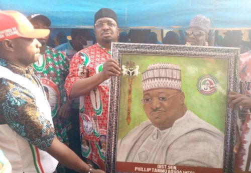 Senator Phillip Aduda being presented with a portrait during his tour to Central ward in Gwagwalada on Saturday