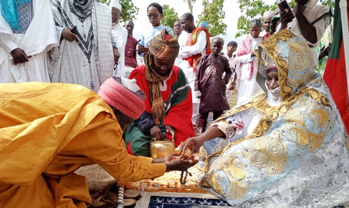 The chief of Pai chiefdom, HRH Alhaji Abubakar Sani Pai gives out cole nut at eid prayer ground on Friday.