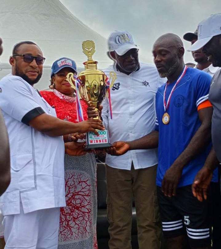 The Kogi State Commissioner for Solid Minerals and Natural Resources, Engineer Abubakar Mohammed Bashir Gegu presenting cup to the overall winner of the competition