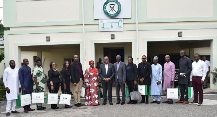 The Managing Director, Chief Executive officer, Federal Housing Authority FHA, Senator Gbenga Ashafa,flanked by The Managing Director, Federal Housing Authority Mortgage Bank FHAMB sorrounded by the beneficiaries and medical doctors during the presentation of keys at the headquarters, Abuja.
