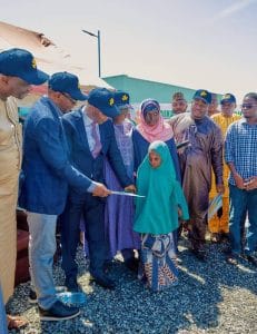 CEO Maikaya Development Foundation, Dr. Musa Muhammed Maikaya supported by Nasarawa State Commissioner for Health, Dr. Gaza Gwamba presenting gift items to beneficiaries recently enrolled into Health Insurance Scheme