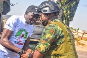 Kogi state Commissioner of Solid Minerals and natural resources, Engr. Mohammed Abubakir Bashir Gegu exchanging pleasantry with a Military officer 