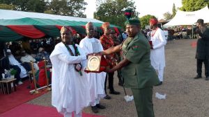 Brigadier General AO Onasanya presenting a prestigious award to an officer of 177 guards battalion.