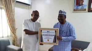 Hon. Barr. Muhammed Tanko Musa (Osuku), the Executive Chairman of Kogi State Civil Service Commission receiving award for his remarkable congratulations to development of Kogi State 