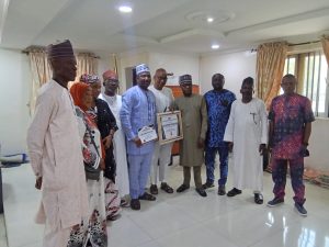 Hon. Barr. Muhammed Tanko Musa (Osuku), the Executive Chairman of Kogi State Civil Service Commission receiving award for his remarkable congratulations to development of Kogi State 