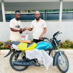Hon. Oladele John Nihi, Special Adviser on Youth & Student Affairs to the Kogi State Governor (R) presenting a brand new motorcycle to Mr. Oloruntoba Victor Dele, from Ila community in Bunu, Kabba-Bunu LGA of Kogi State