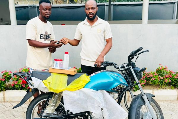 Hon. Oladele John Nihi, Special Adviser on Youth & Student Affairs to the Kogi State Governor (R) presenting a brand new motorcycle to Mr. Oloruntoba Victor Dele, from Ila community in Bunu, Kabba-Bunu LGA of Kogi State