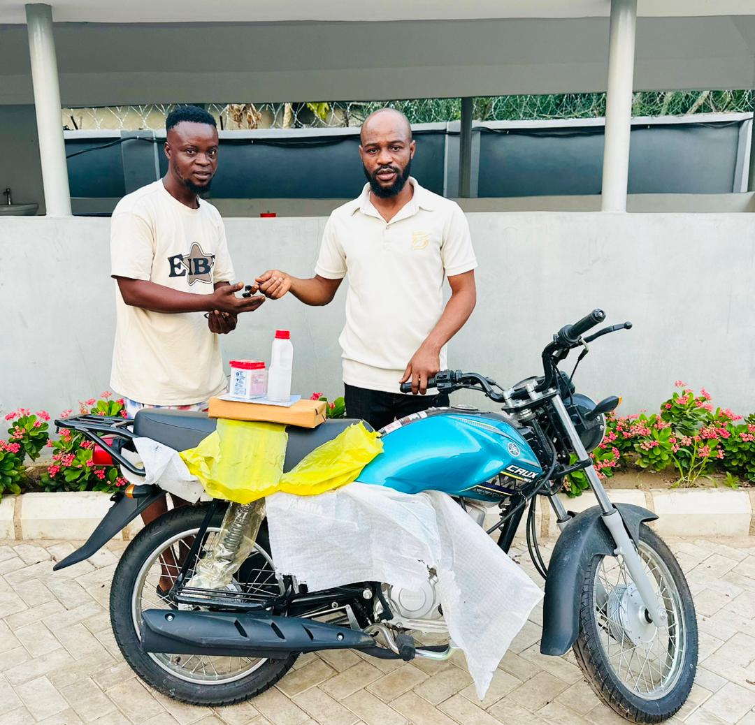 Hon. Oladele John Nihi, Special Adviser on Youth & Student Affairs to the Kogi State Governor (R) presenting a brand new motorcycle to Mr. Oloruntoba Victor Dele, from Ila community in Bunu, Kabba-Bunu LGA of Kogi State