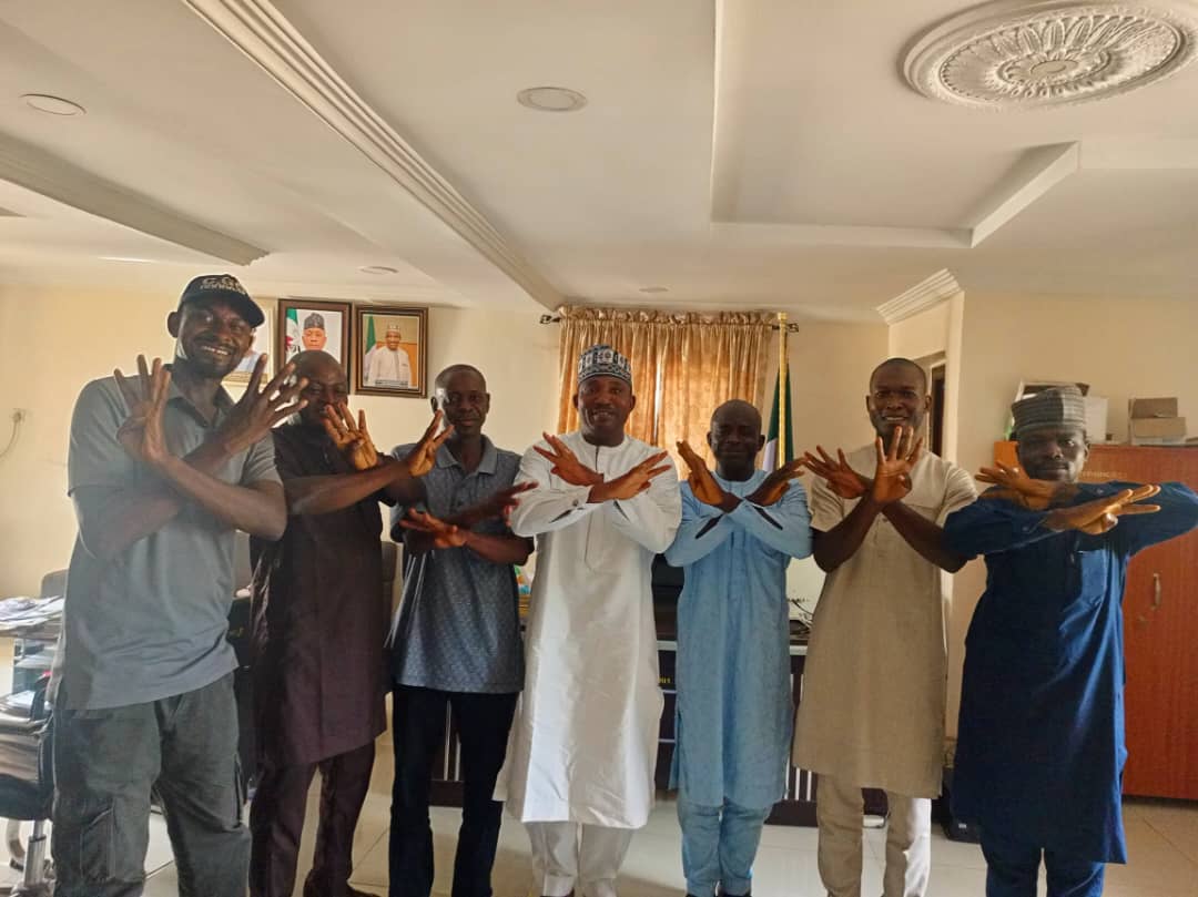 Hon. Barr. Muhammed Musa Tanko Osuku, Chairman Kogi State Civil Service Commission (m) in white, in a group photograph with delegation of former council officials and secretary in the State Civil Service Commission House Lokoja