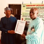 The DG, Searchlight Security initiative presenting an Honorary Award to the Chairman, Karu. LG