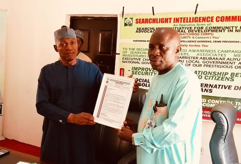 The DG, Searchlight Security initiative presenting an Honorary Award to the Chairman, Karu. LG
