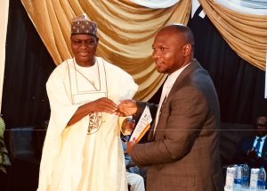 The NSHA Speaker Dr. Danladi Jatau while presenting an award to Commissioner for health Dr Gaza Gwamna during NARD Zonal event.