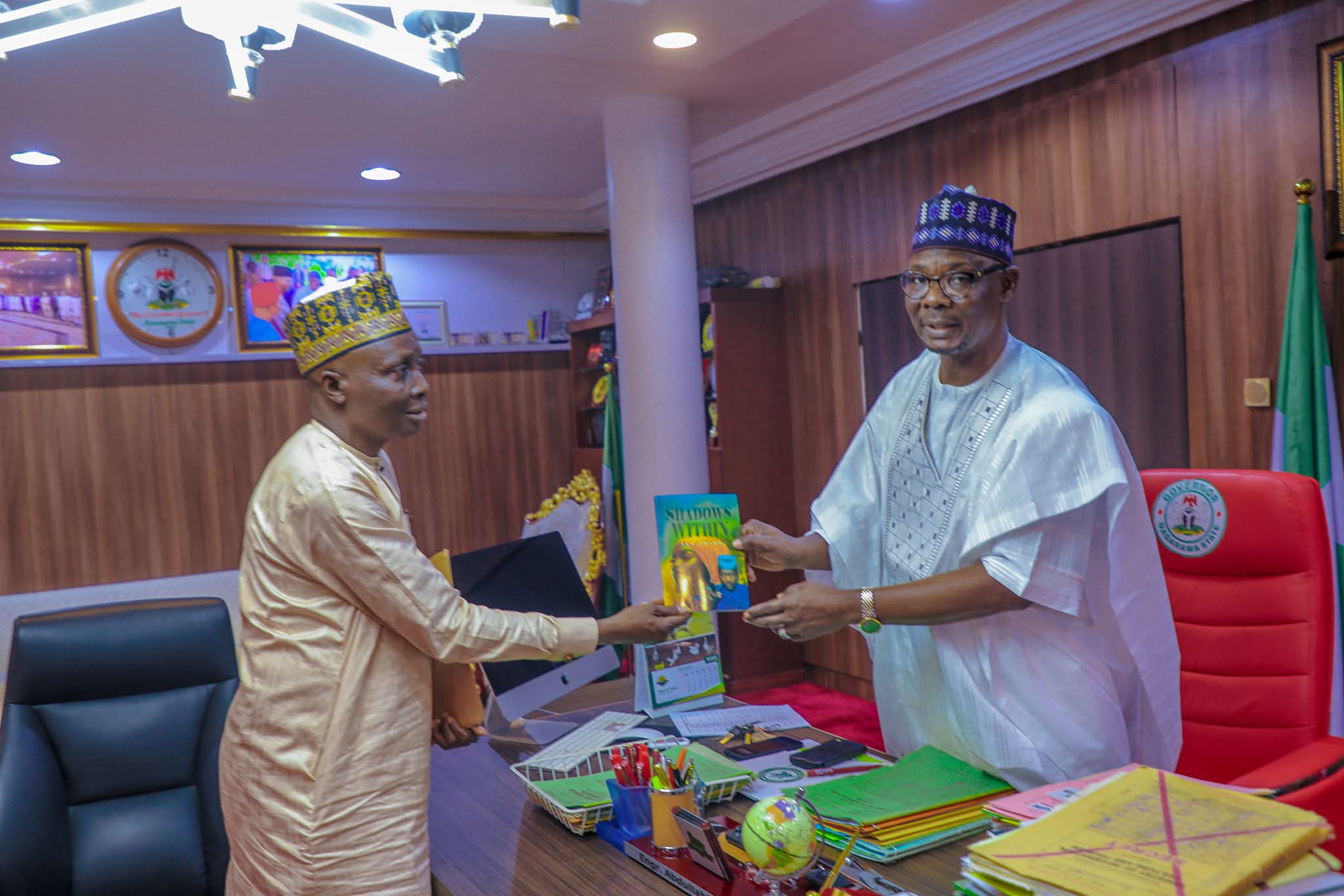 Mallam Ali Abare, Senior Special Assistant on Media presenting his book to Governor Abdullahi Sule of Nasarawa State