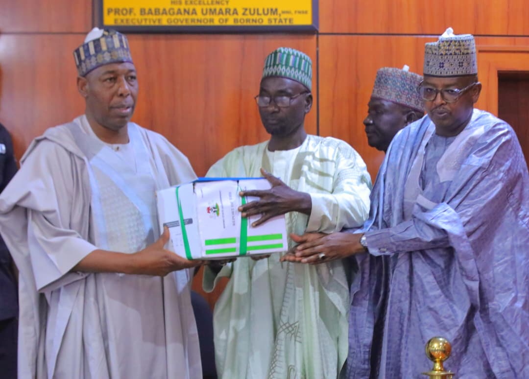 Borno State Governor Professor Babagana Umara Zulum (Left) receiving a committee report on the repositioning of technical and vocational education from the Chairman, Alhaji Goni Ibrahim (Middle), assisted by the Commissioner of Education, Engr Lawan Abba Wakilbe (Right)