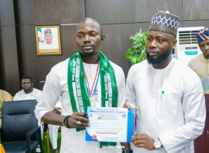 Comrade Abdulrahman Abdulmumuni Enesi, the Chairman NYCN Kogi State Chapter  and Hon. Monday Aridaojo Anyebe,  Kogi State Commissioner for Youth and Sports Development 