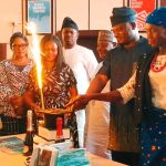 Dr. Monday Abimiku with his family members cutting the birthday cake during his book launch