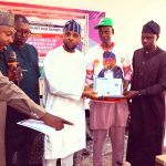 Hon. Gaza, presenting certificate of participation to one of the beneficiaries.