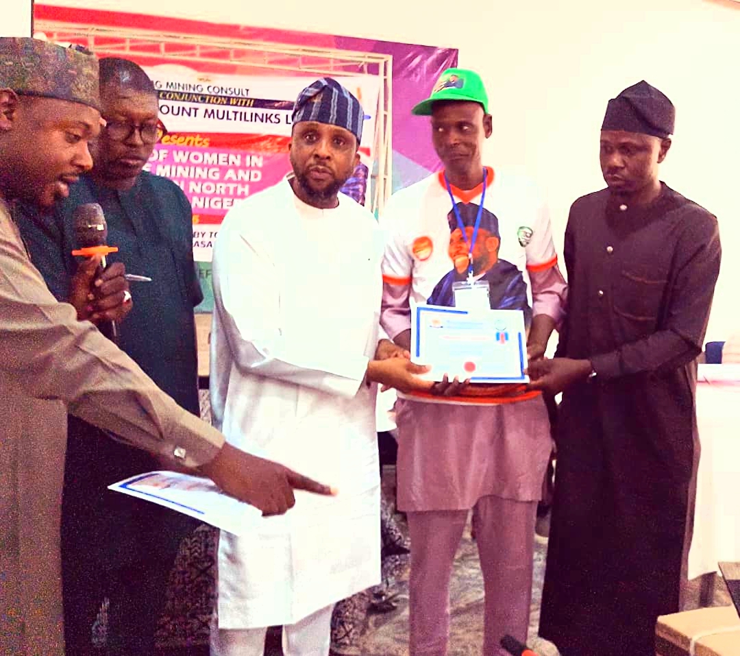 Hon. Gaza, presenting certificate of participation to one of the beneficiaries.