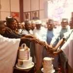Amb. Musa Yakubu with dignitaries while cutting a birthday cake.