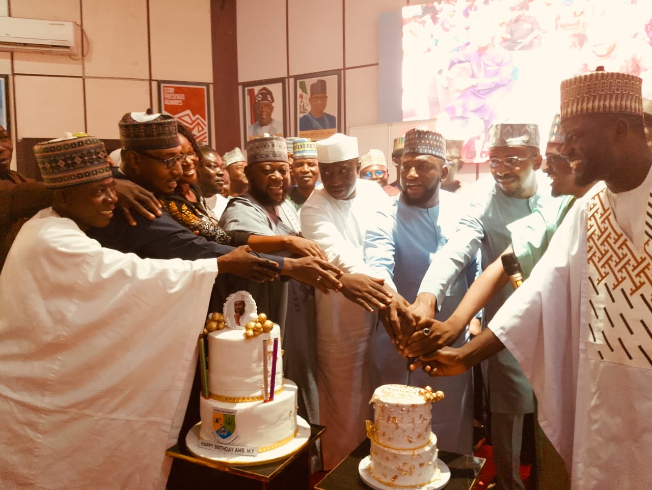 Amb. Musa Yakubu with dignitaries while cutting a birthday cake.
