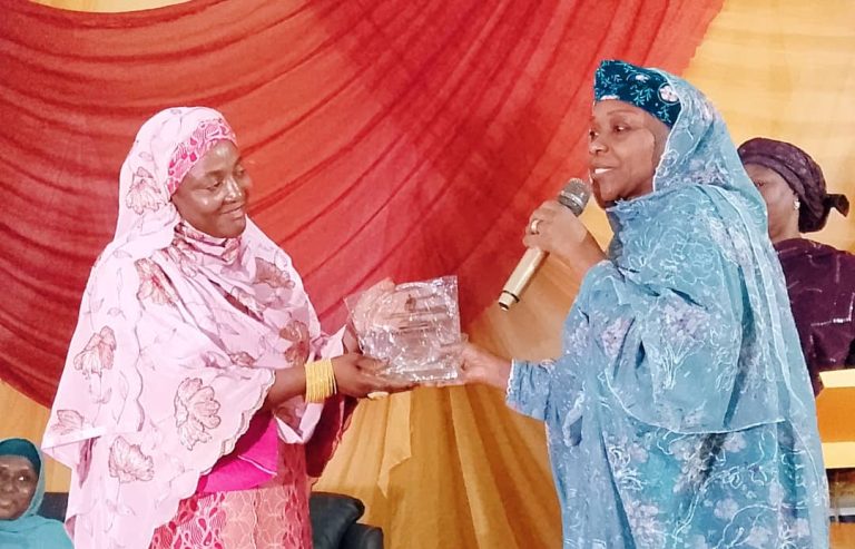 The commissioner for finance, Hajiya Munira Abdullahi, receiving the award on behalf of Governor Abdullahi Sule.