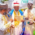Executive Chairman Kogi State Civil Service Commission, Hon. Barr. Muhammed Tanko Musa Osuku middle with his certificate of Chieftaincy Title conferment of Aijimi Egwo translated into English as one that wipe tears