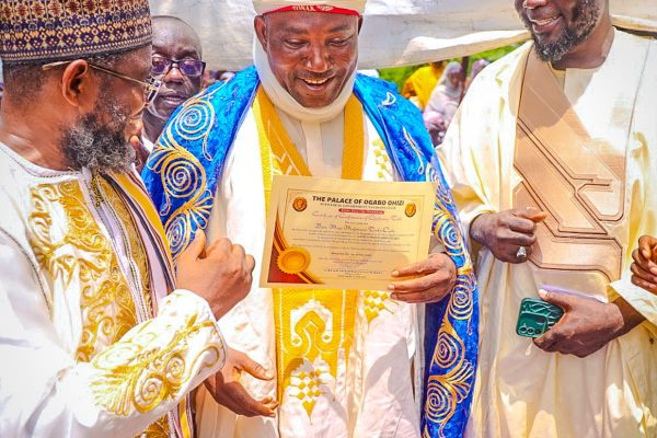 Executive Chairman Kogi State Civil Service Commission, Hon. Barr. Muhammed Tanko Musa Osuku middle with his certificate of Chieftaincy Title conferment of Aijimi Egwo translated into English as one that wipe tears