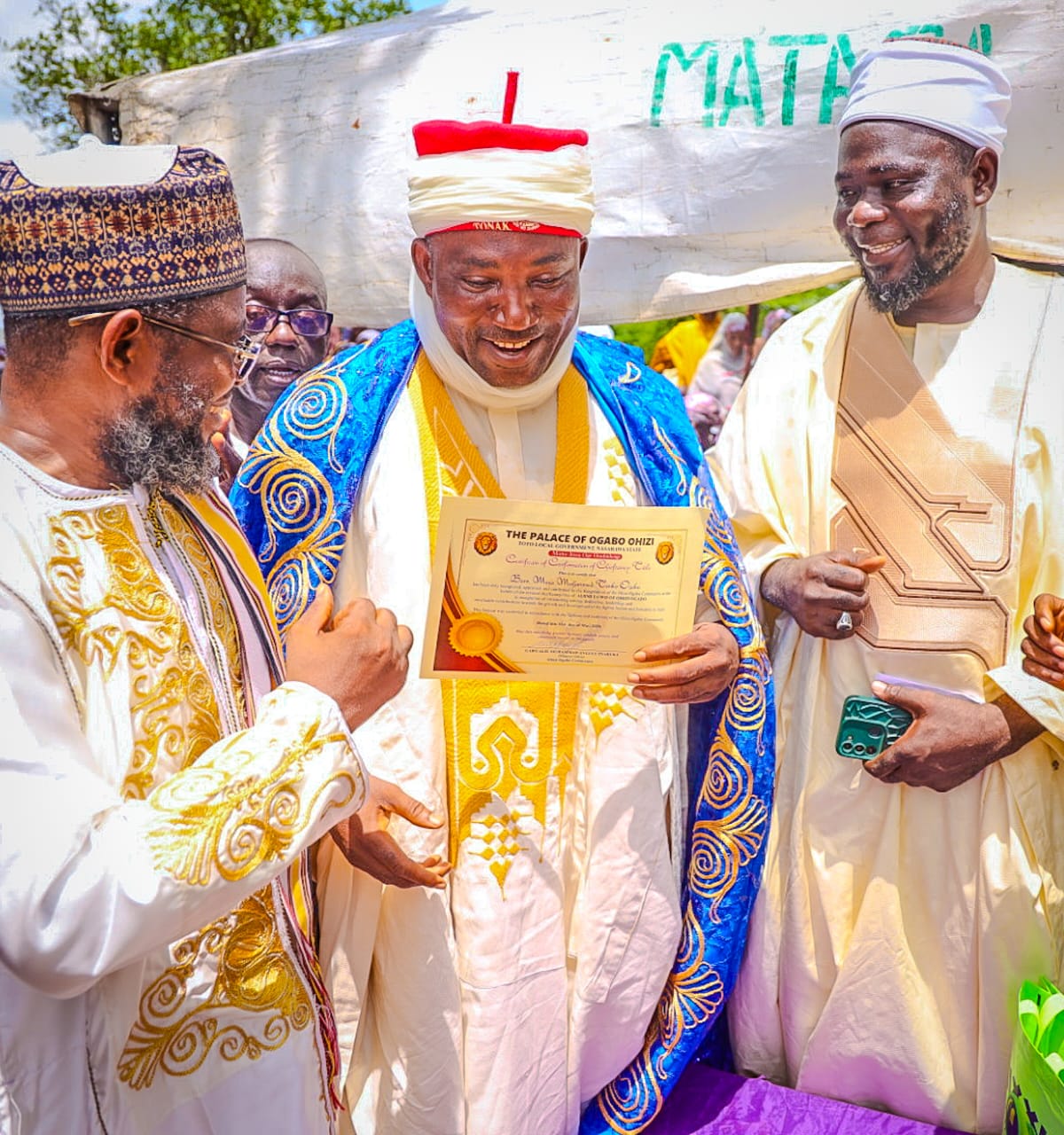 Executive Chairman Kogi State Civil Service Commission, Hon. Barr. Muhammed Tanko Musa Osuku middle with his certificate of Chieftaincy Title conferment of Aijimi Egwo translated into English as one that wipe tears