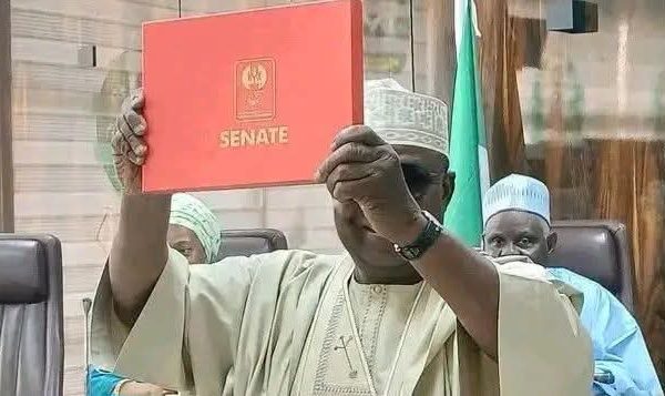 Senator elect, Danladi Envulu Anza while receiving his certificate of return at the INEC headquarters in Abuja.
