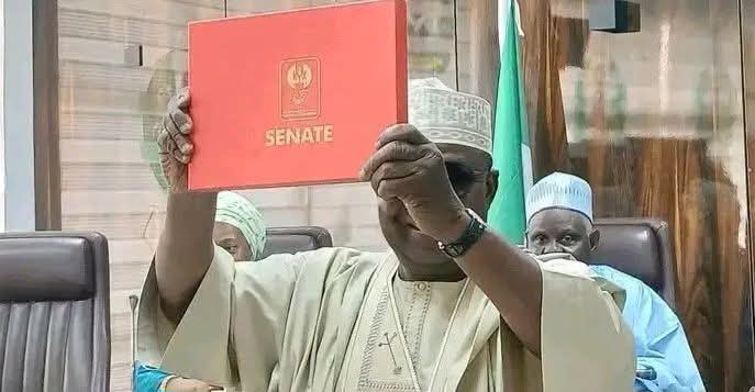 Senator elect, Danladi Envulu Anza while receiving his certificate of return at the INEC headquarters in Abuja.