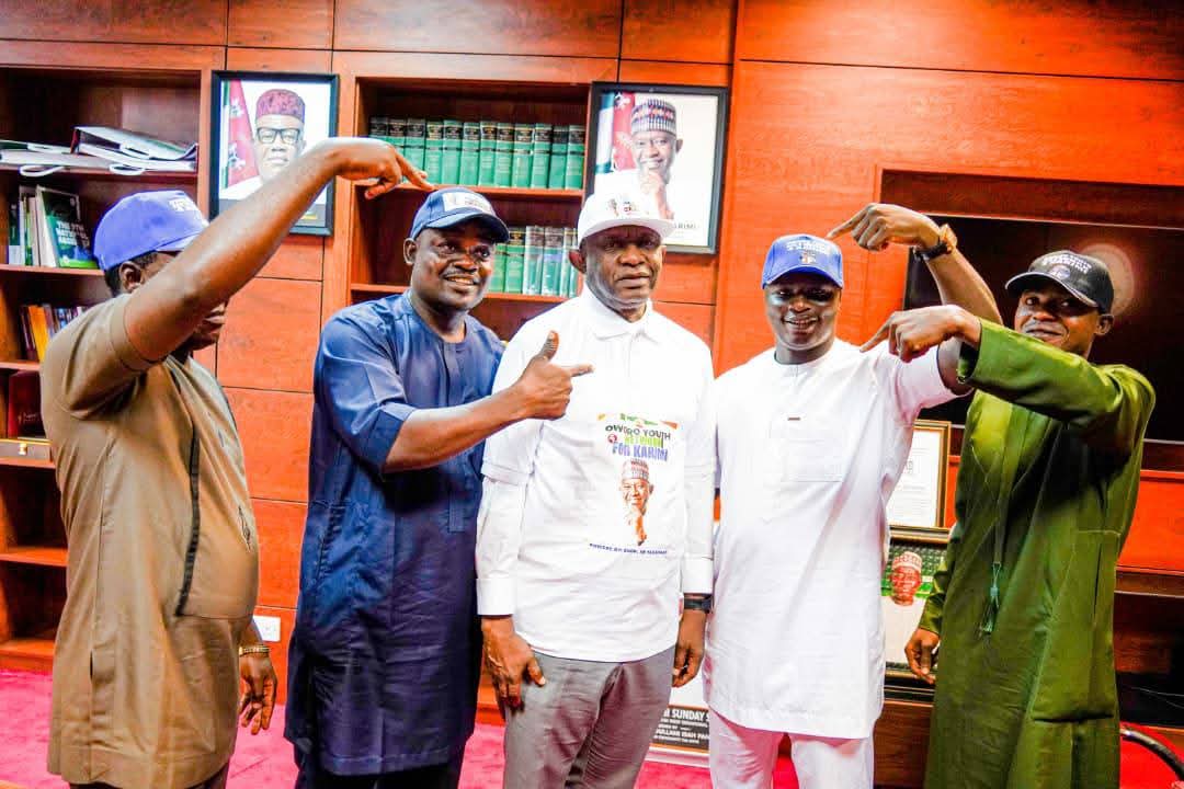 Senator Sunday Steve Karimi receives branded campaign materials from members of the Oworo Youth Network during a solidarity visit in Abuja ahead of the 2027 elections.