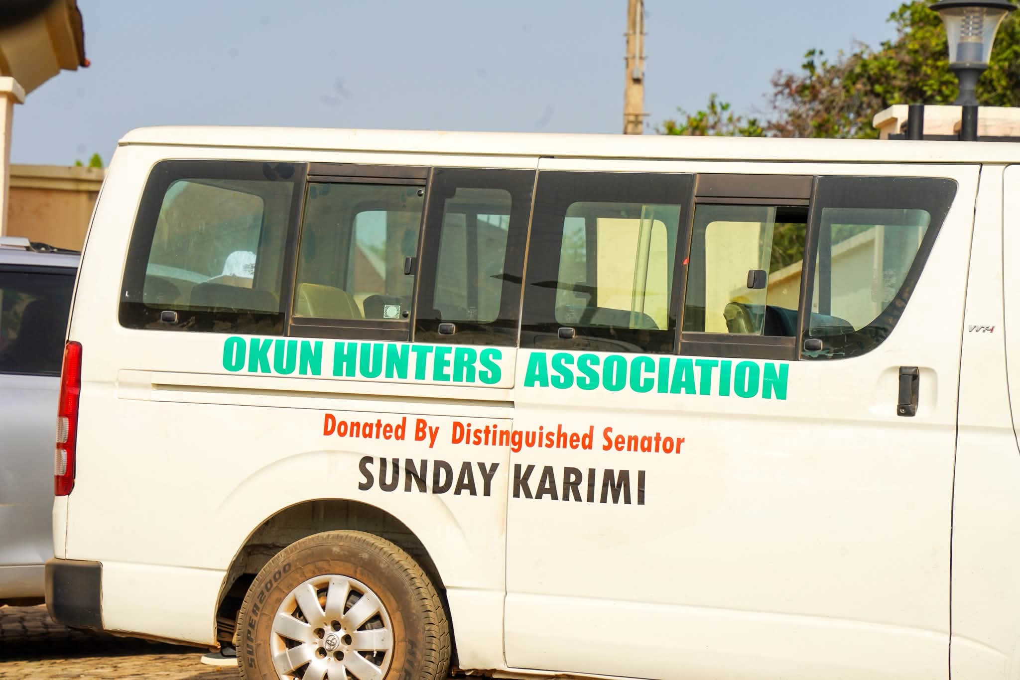 Senator Sunday Karimi's reported donation of an 18-seater bus and six motorcycles to community security groups in Kogi West.